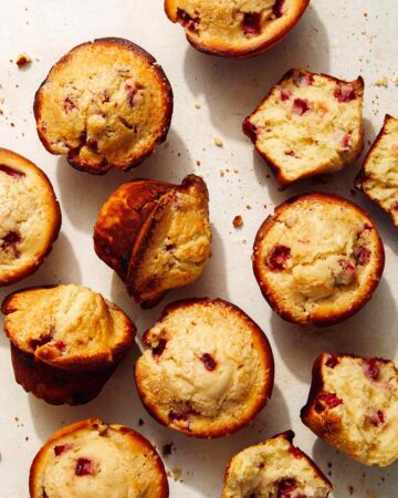 Freshly baked strawberry muffins on a counter.