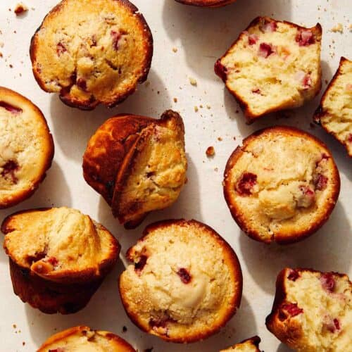 Freshly baked strawberry muffins on a counter.