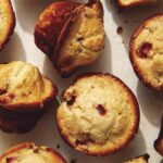 Freshly baked strawberry muffins on a counter.