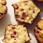 Close up on one strawberry muffin recipe that is ripped open.