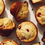 Freshly baked strawberry muffins on a counter.