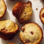 Strawberry muffins on a counter with one ripped open.