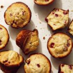 Freshly baked strawberry muffins on a counter.