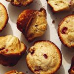 Freshly baked strawberry muffins on a counter.