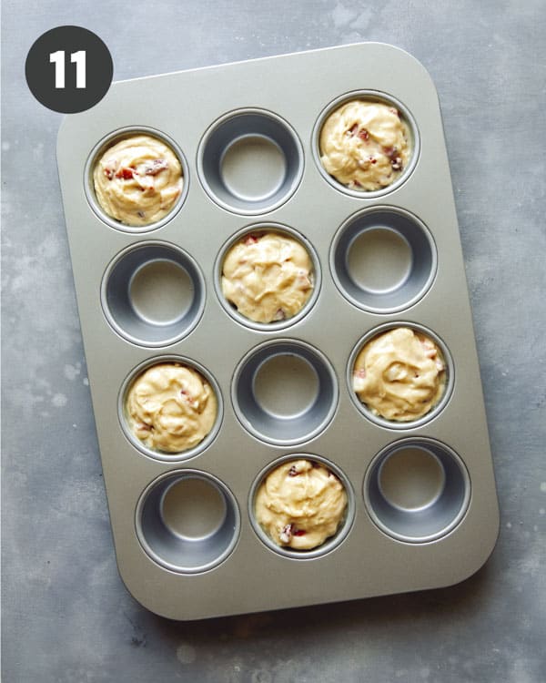 Muffin batter in a muffin tin ready to be baked.