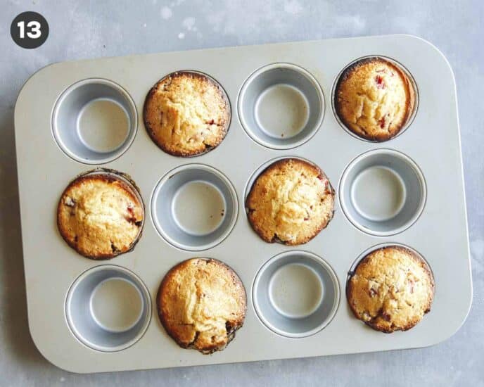Strawberry muffins freshly baked in a muffin tin.