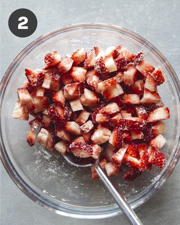 Strawberries mixed in a bowl for strawberry muffins.