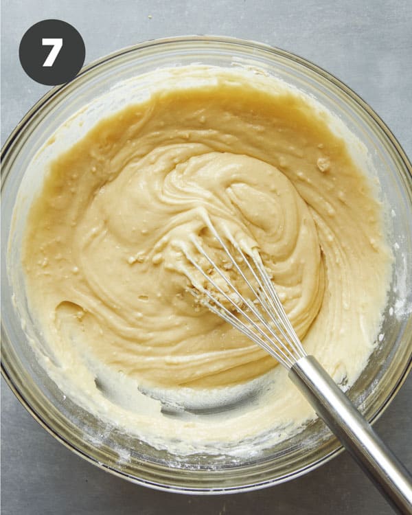Muffin batter freshly whisked together in a glass bowl.