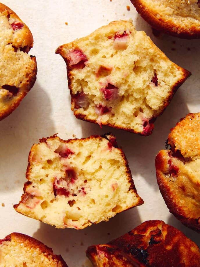 Close up on one strawberry muffin recipe that is ripped open.