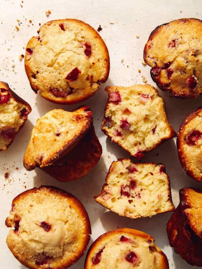 Strawberry muffins on a counter with one ripped open.