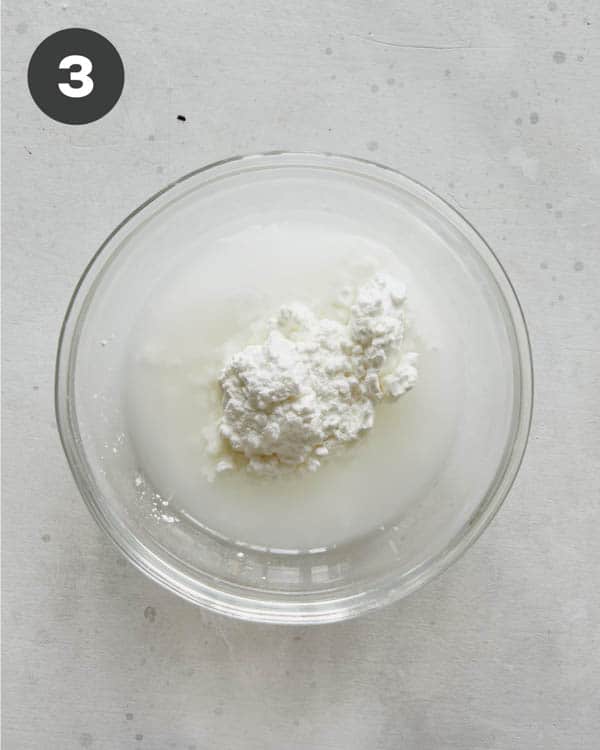 Cornstarch and water in a bowl to make a slurry for sweet chili sauce.