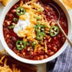 Kitchen sink chili in a bowl loaded with toppings.