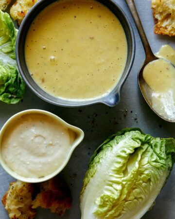 Caesar salad dressing recipe with lettuce on the side.