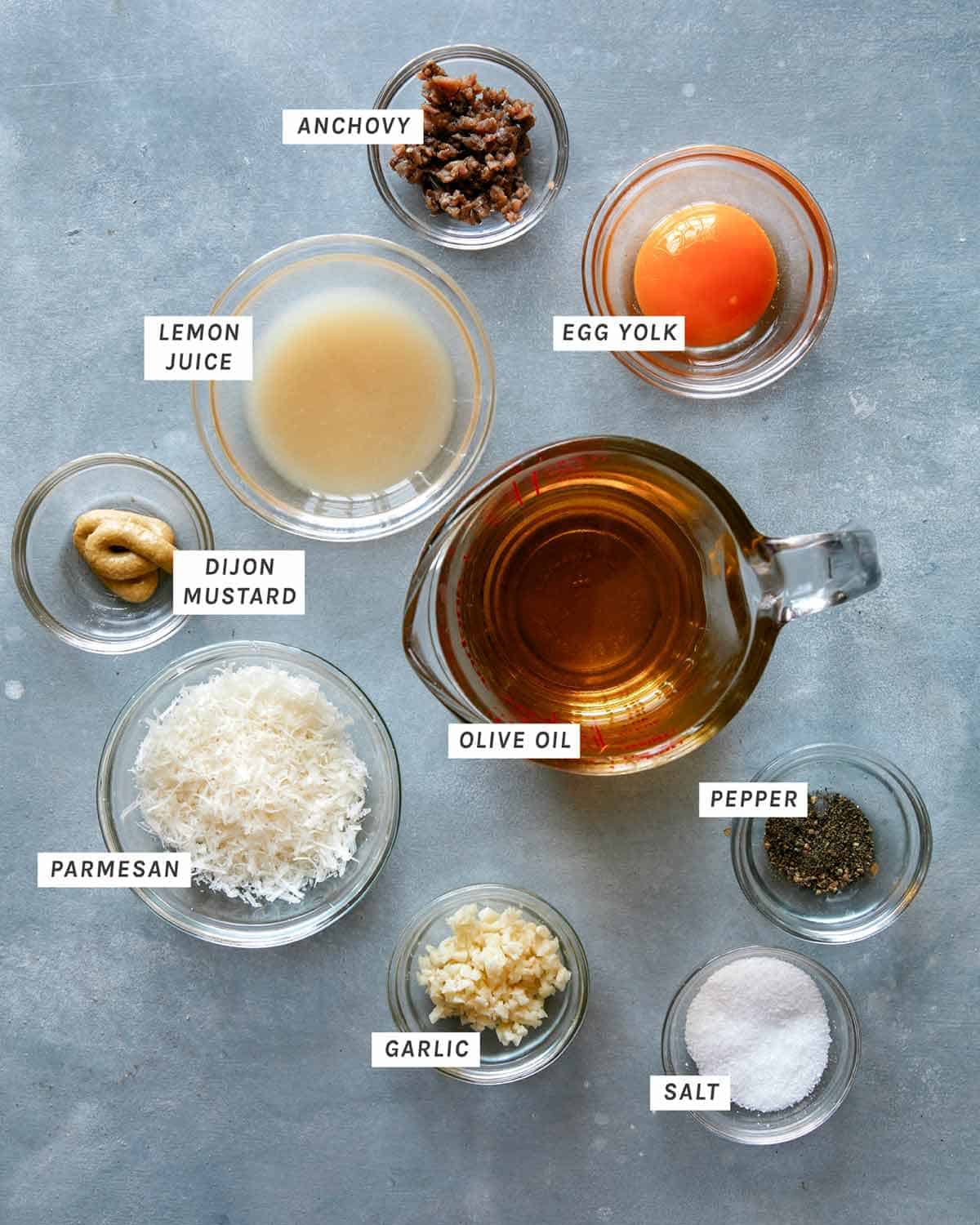 Caesar salad dressing ingredients on a kitchen counter. 