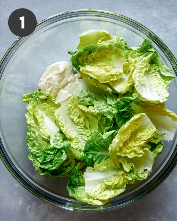 Caesar salad ingredients in a bowl.