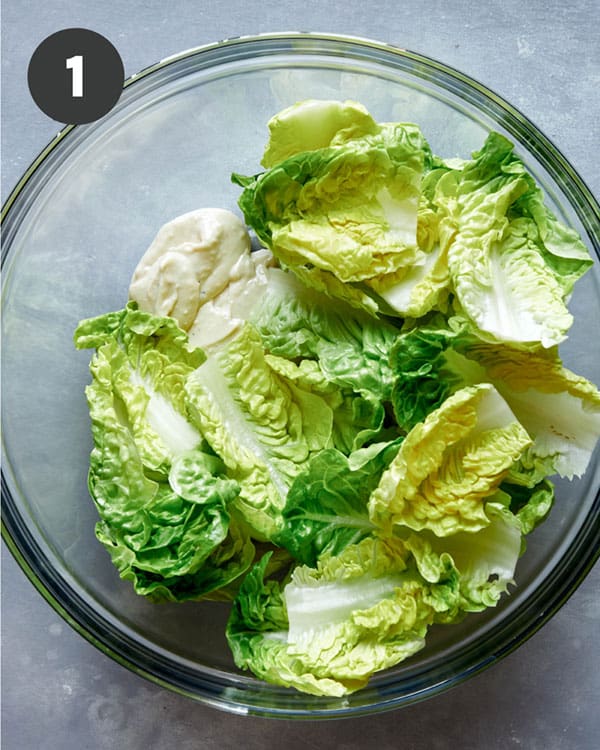 Caesar salad ingredients in a bowl. 