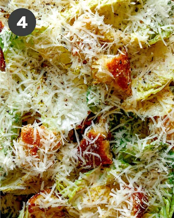Caesar salad on a platter with parmesan on top. 