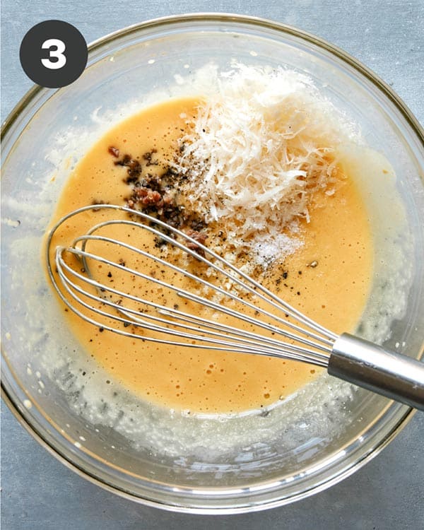 Caesar salad dressing ingredients being whisked together. 