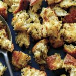 Homemade croutons recipe on a platter with a spoon.