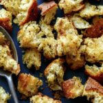 Homemade croutons recipe on a platter with a spoon.