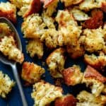 Homemade croutons recipe on a platter with a spoon.