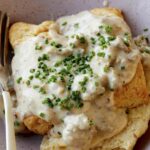 Biscuits and gravy in a bowl.