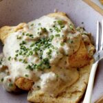 Biscuits and gravy in a bowl.