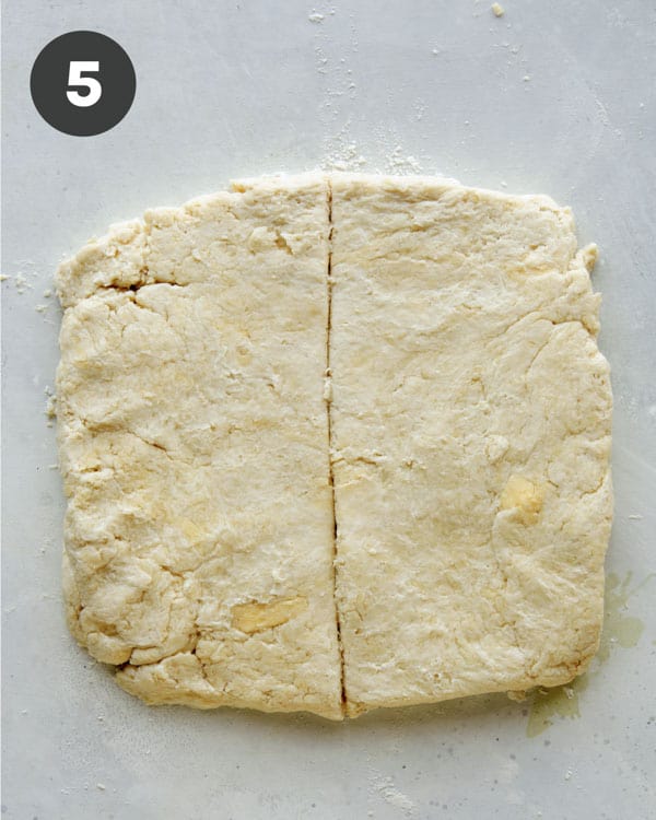 Biscuit dough on a surface.