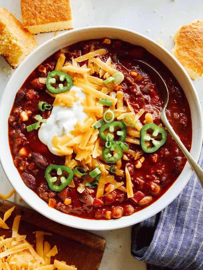 Kitchen sink chili in a bowl with cornbread on the side.