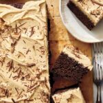 Chocolate sheet cake with peanut butter frosting on a board.