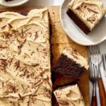 Chocolate sheet cake with peanut butter frosting on a board.