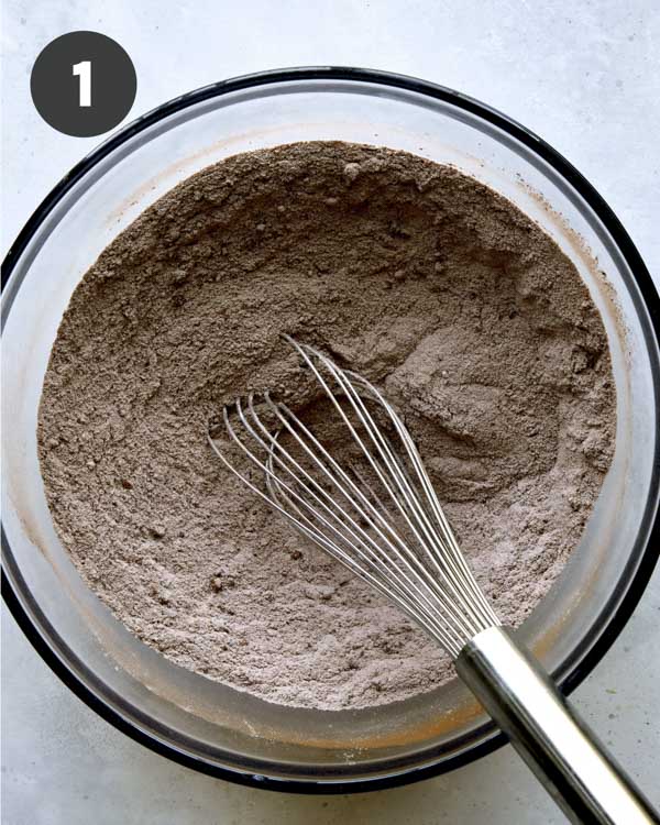 Dry ingredients mixed in a bowl for chocolate sheet cake.