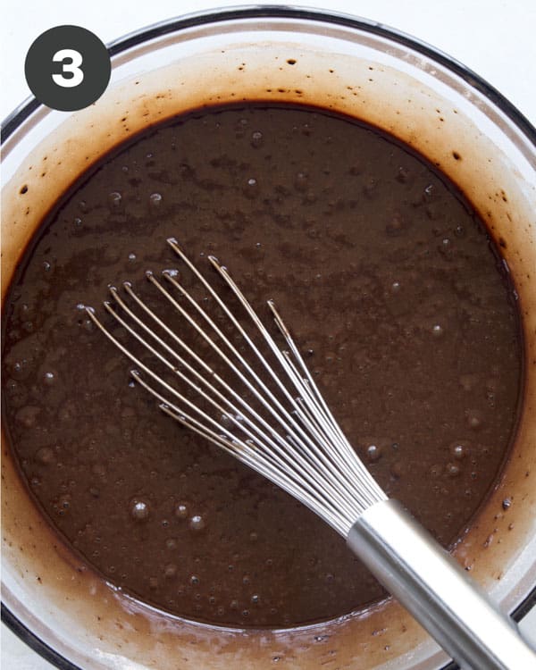 The batter to make cake in a glass bowl.