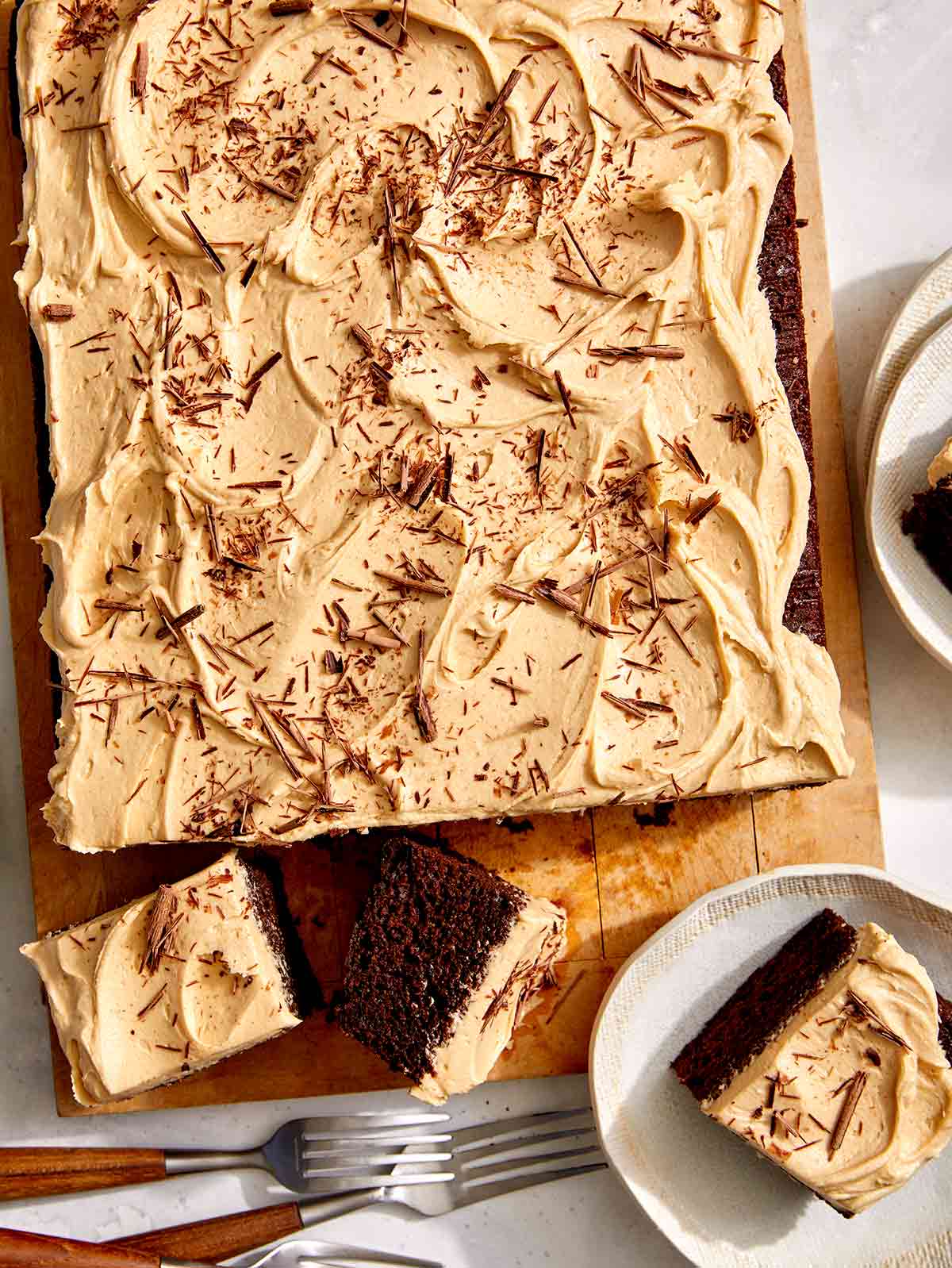 Chocolate sheet cake with peanut butter frosting on a board. 