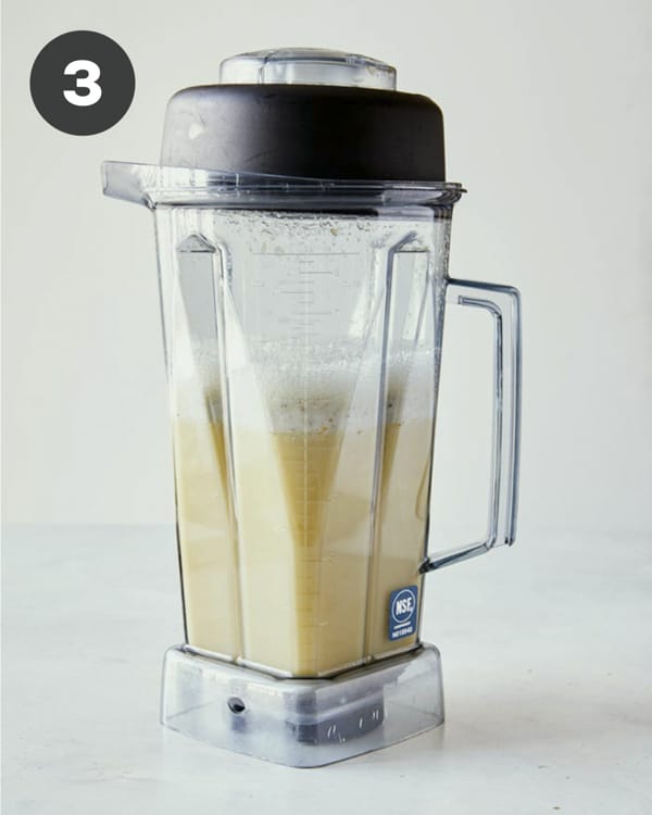Blended corn and stock in a blender to make corn chowder.