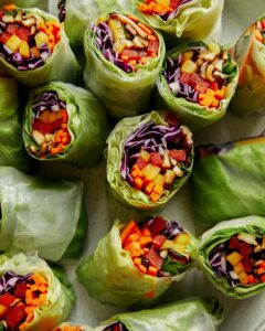 A platter full of fresh spring rolls.