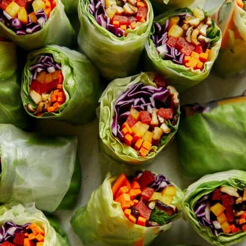 A platter full of fresh spring rolls.