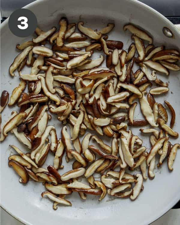 Mushrooms cooking in a skillet to make fresh spring rolls.