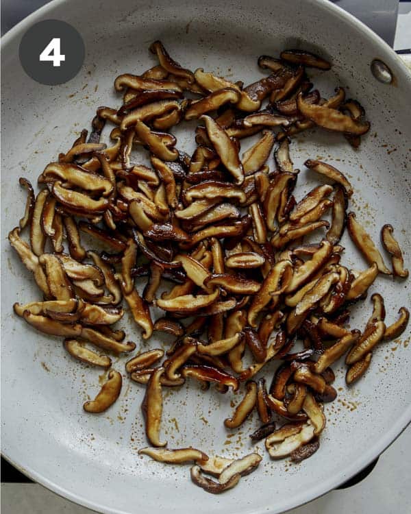 Cooked mushrooms in a skillet to make spring rolls.