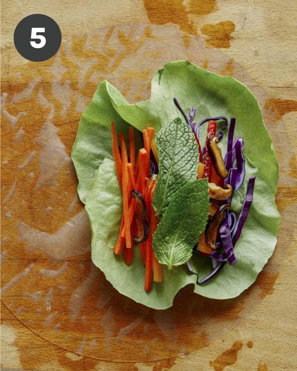 Spring rolls being made with fresh ingredients. 