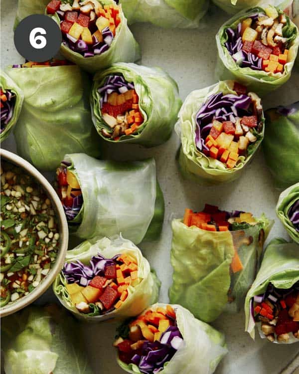 A platter of fresh spring rolls cut in half.