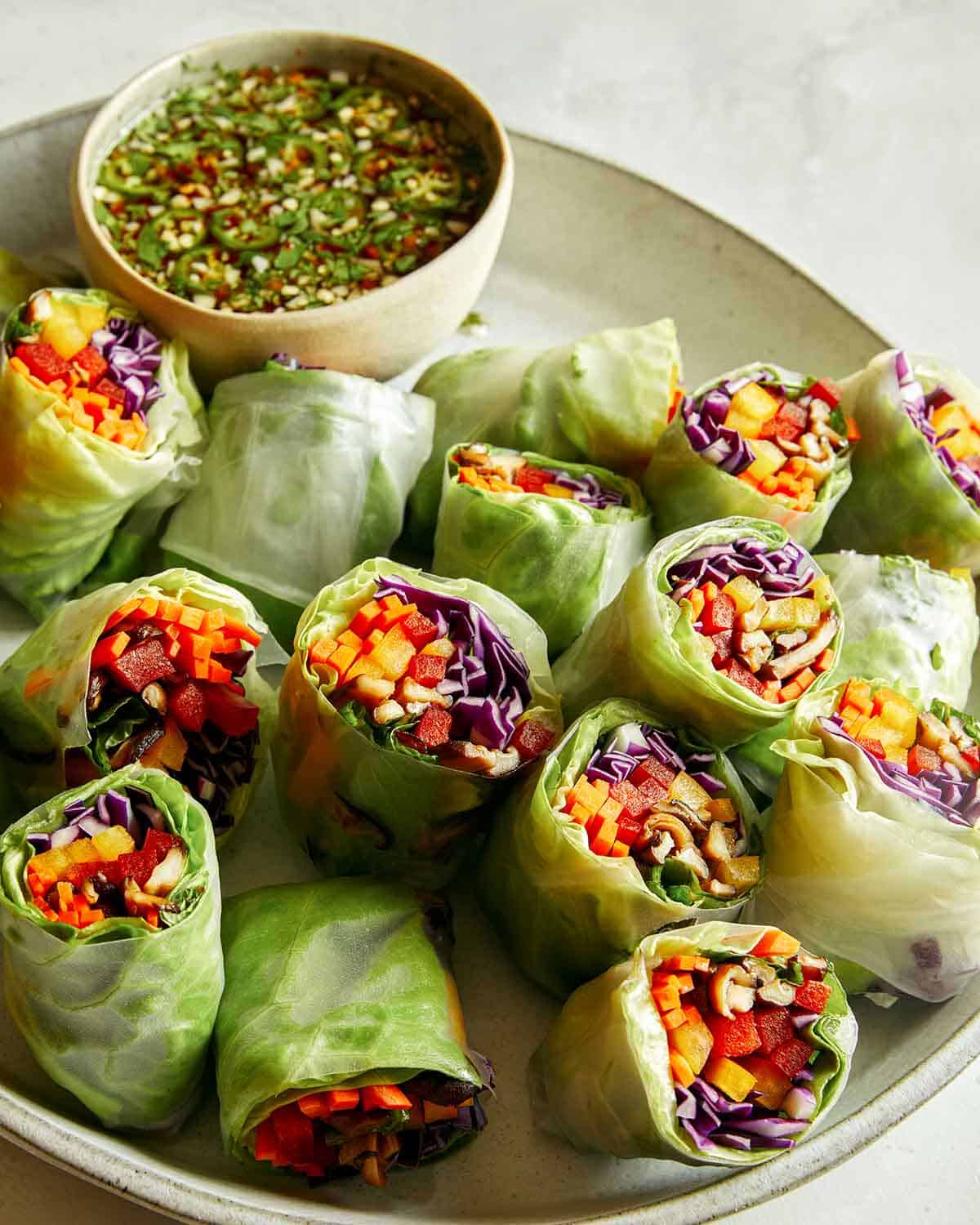 Fresh spring rolls on a platter with dipping sauce. 