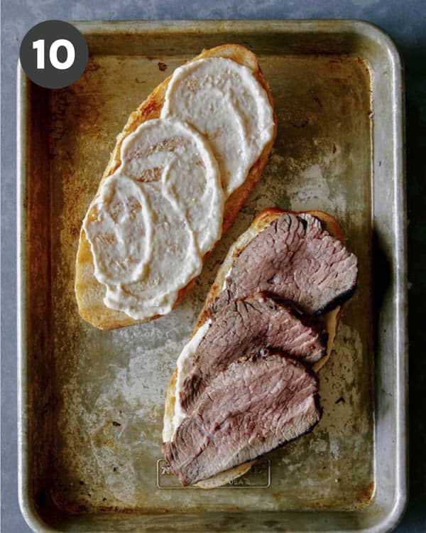 An open sandwich with tri tip on one side.