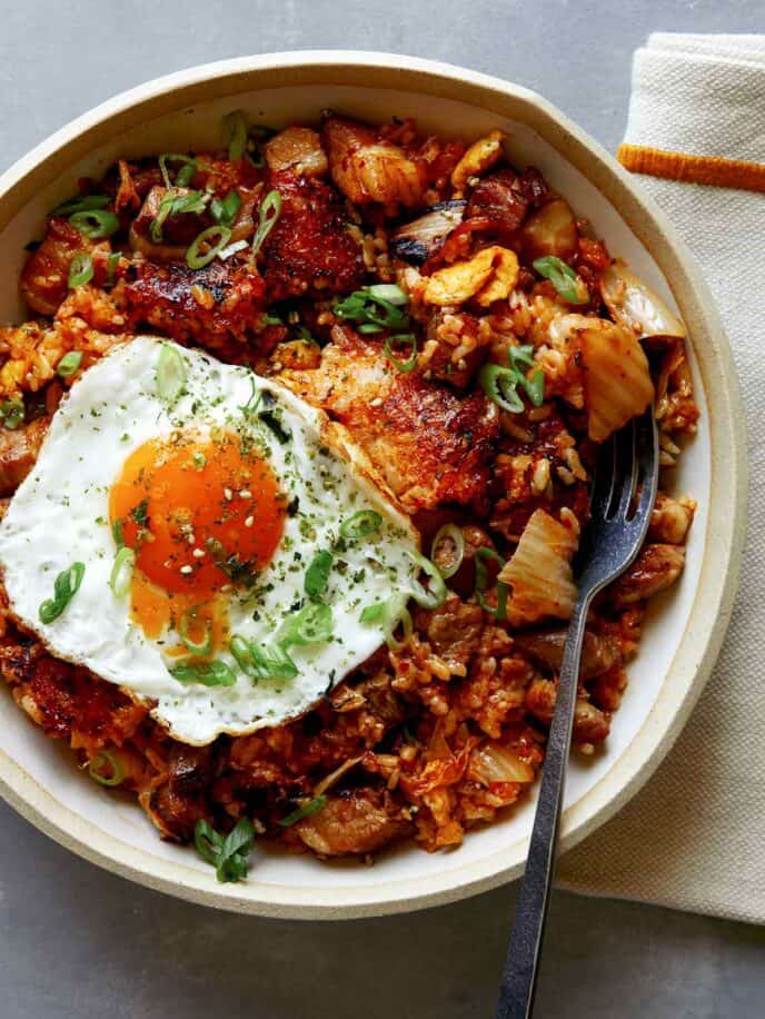 Kimchi fried rice in a bowl with a fork in it.