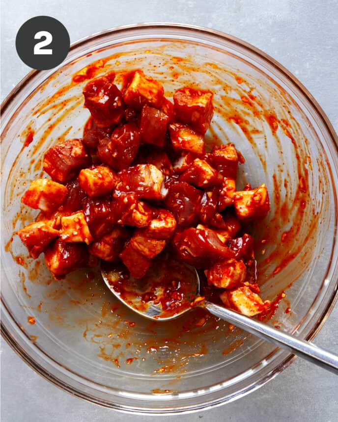 Marinated pork belly in a glass bowl. 