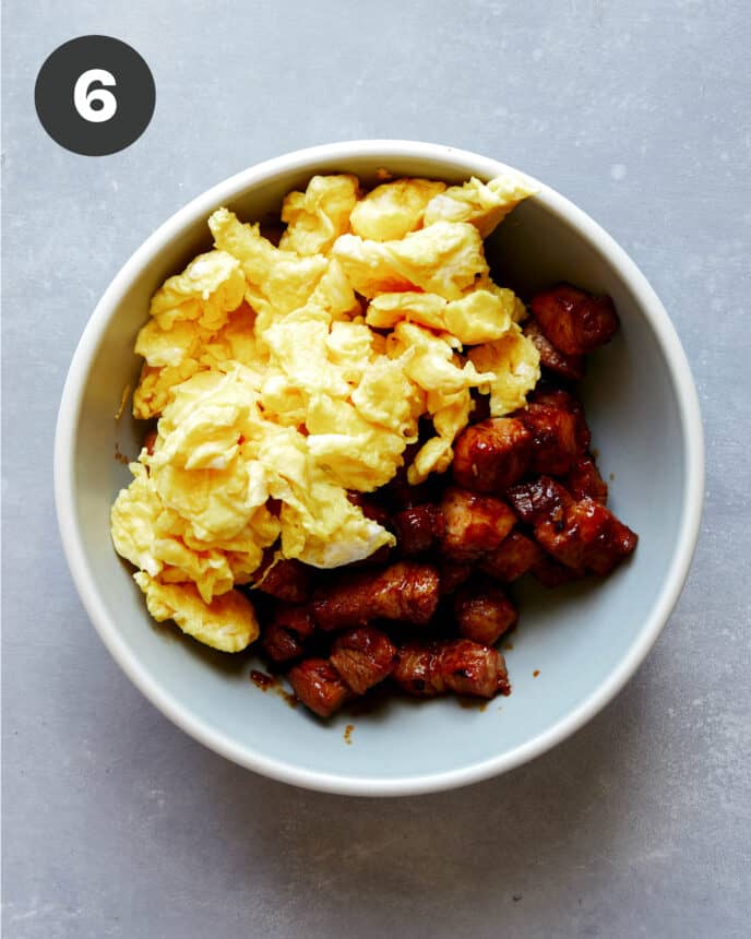 Pork belly with eggs in a bowl.