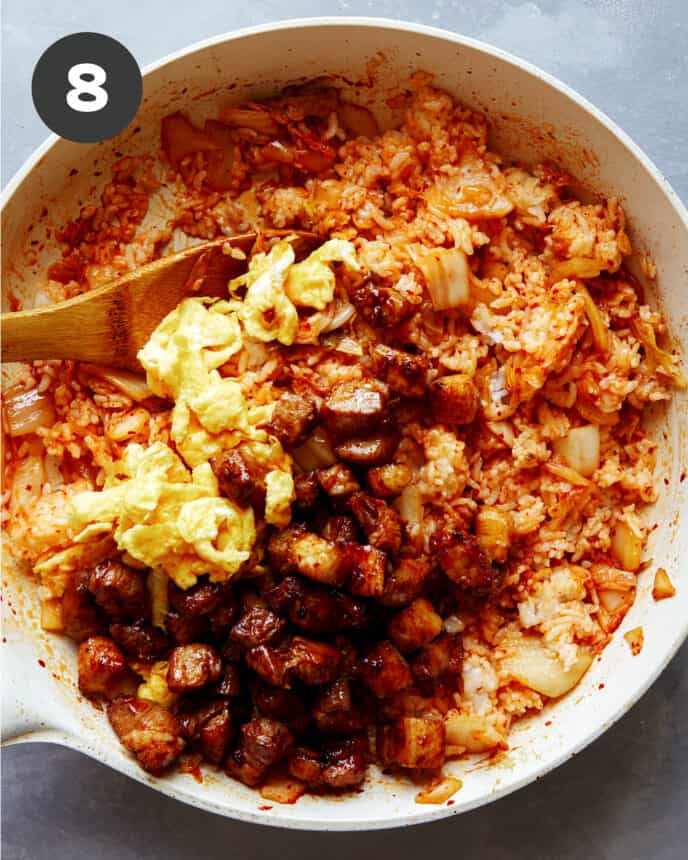 Kimchi fried rice ingredients in a skillet cooking.