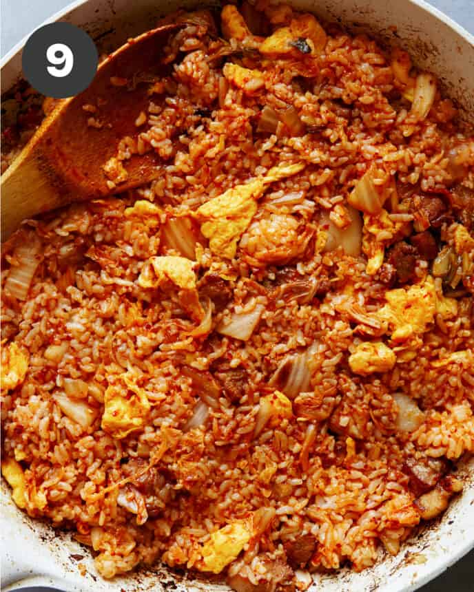 Kimchi fried rice cooking in a skillet. 