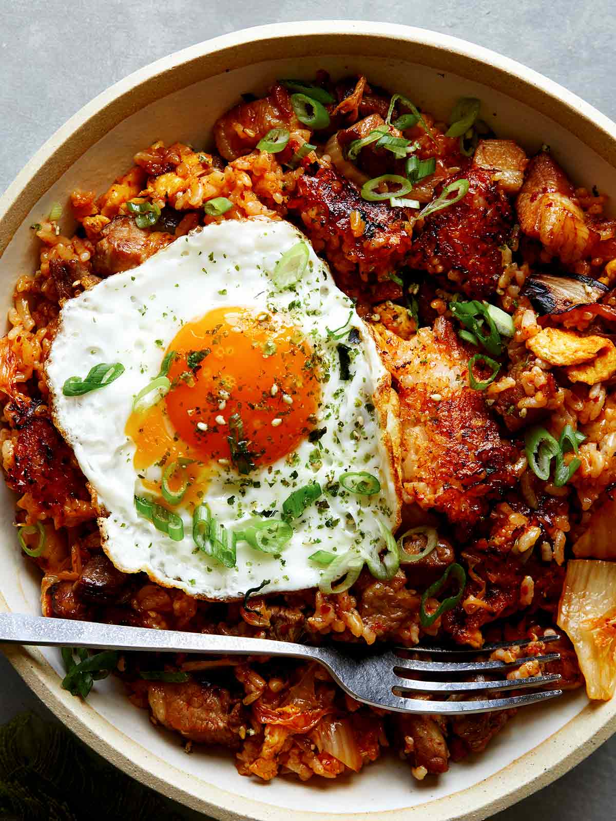 Kimchi fried rice in a bowl with a fried egg on top. 