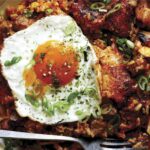 Kimchi fried rice in a bowl with a fried egg.